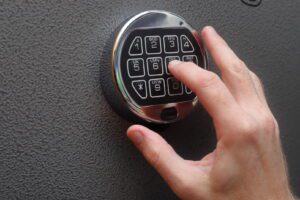 Hand Enters Combination On Digital Lock On A Gun Safe